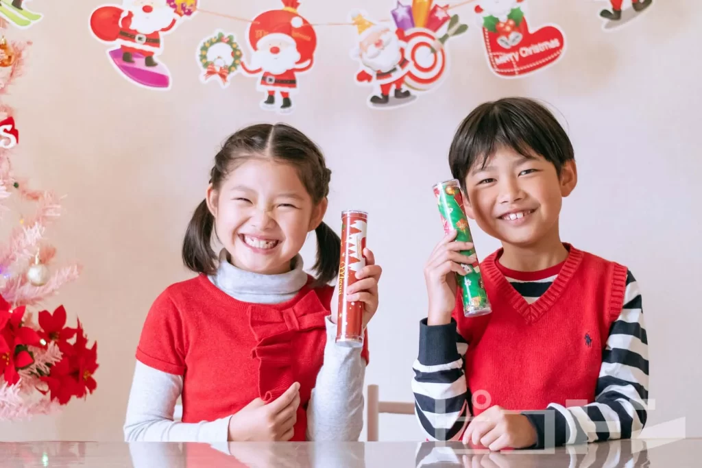 『クリスマス宝石万華鏡』を持つ女の子と男の子